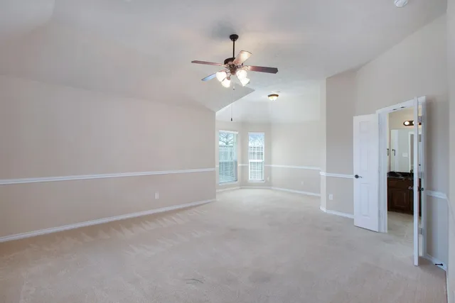 a view of a livingroom with a ceiling fan and window