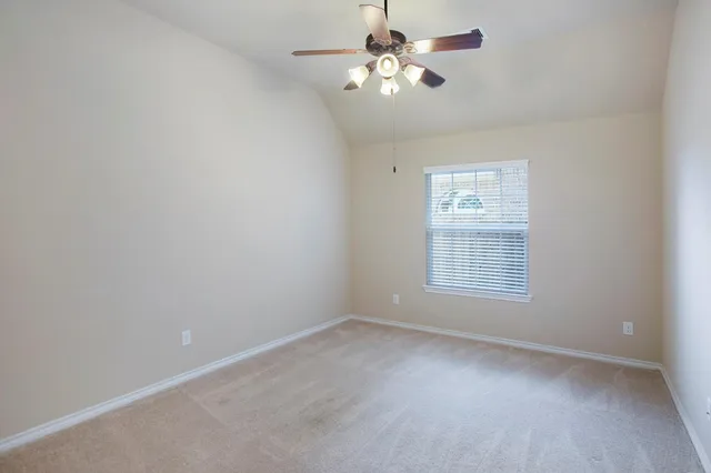 a bathroom with a granite countertop sink toilet and mirror