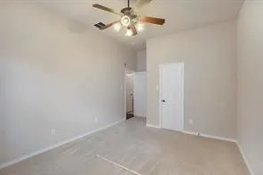 a view of an empty room with a chandelier fan