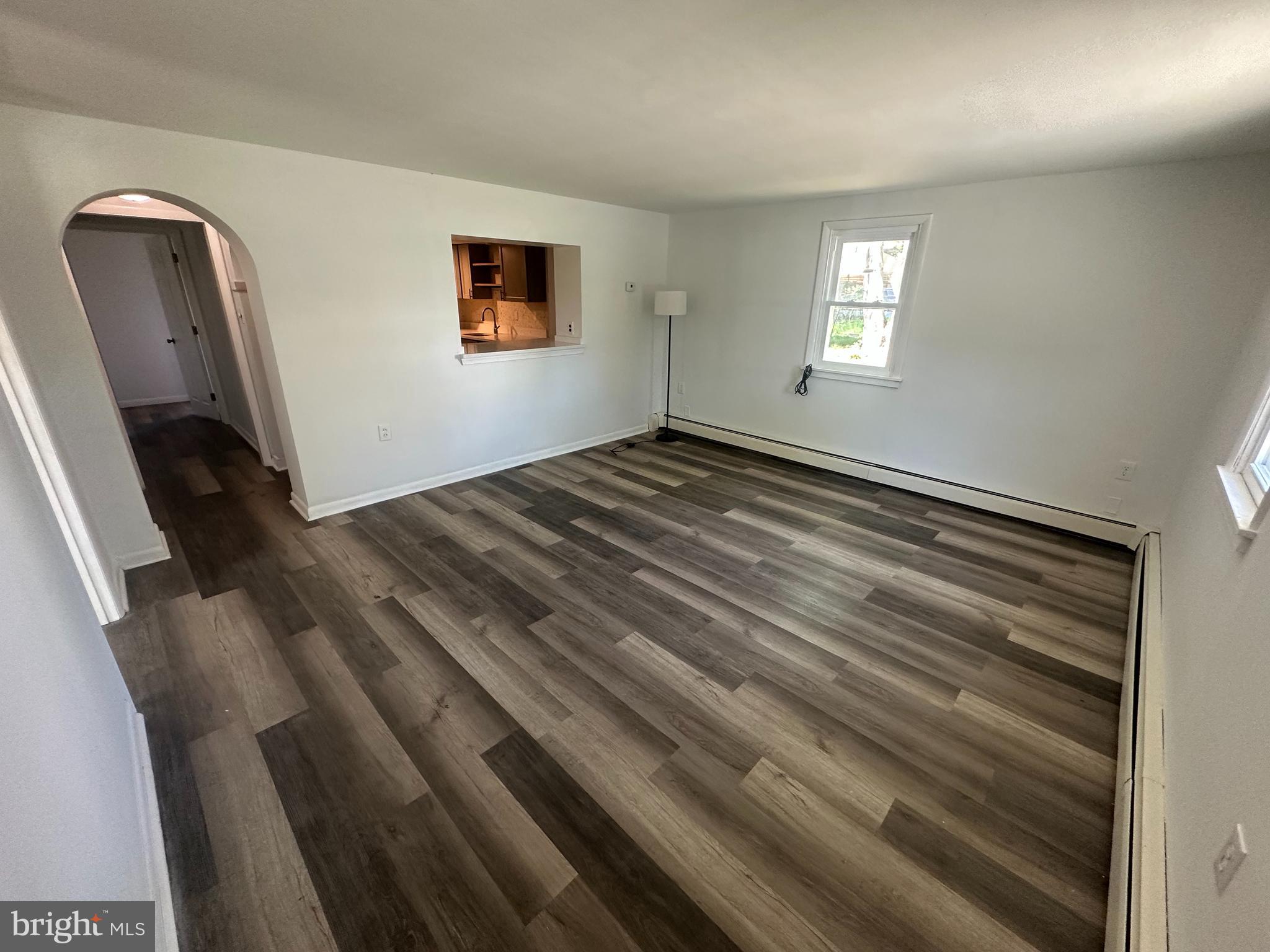 1411 Zebley Road, Unit A Garnet Valley, PA 19060 - Photo 3 of 17 a view of an empty room with wooden floor and a window