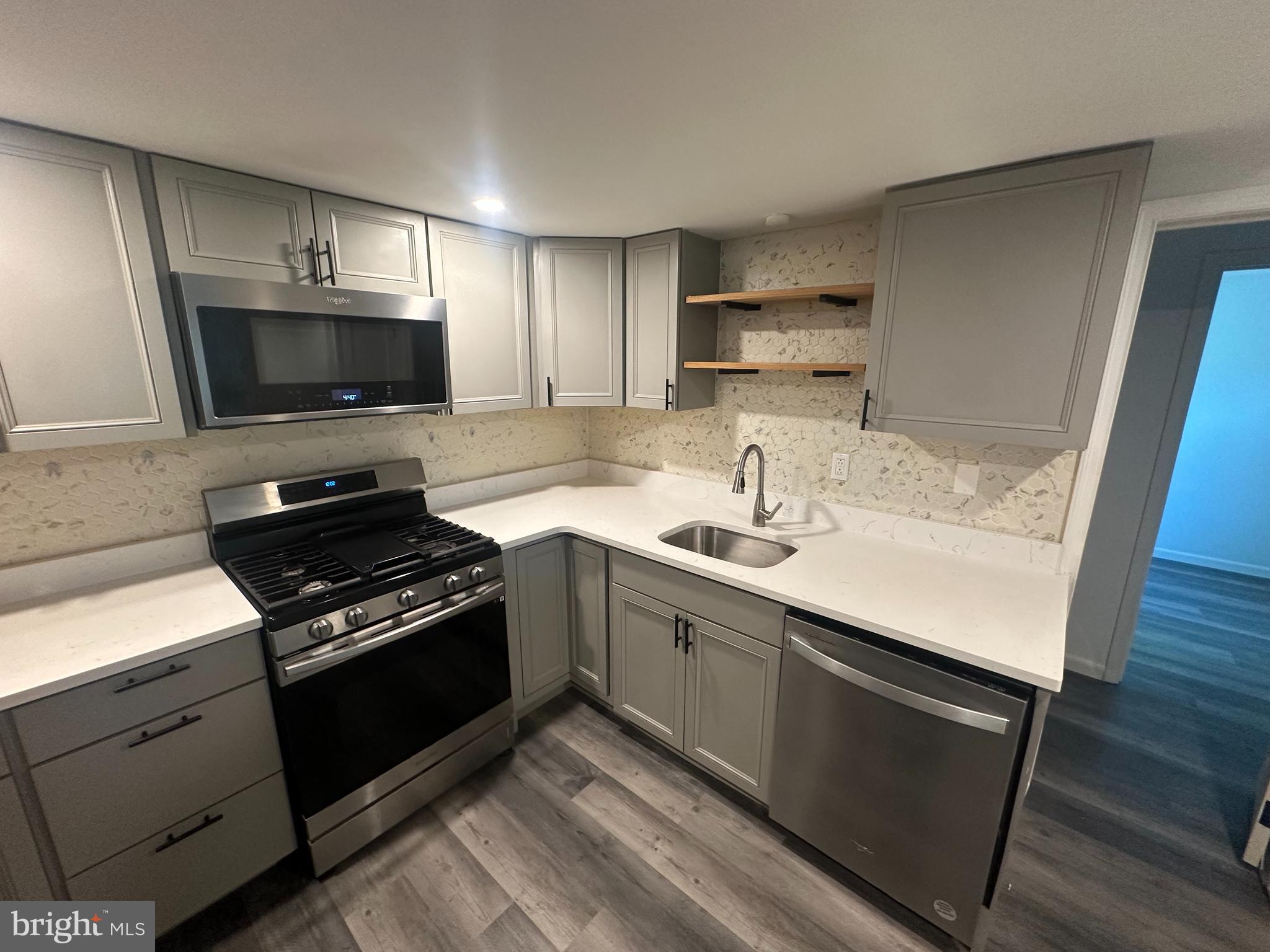 1411 Zebley Road, Unit A Garnet Valley, PA 19060 - Photo 10 of 17 a kitchen with a sink stove and microwave