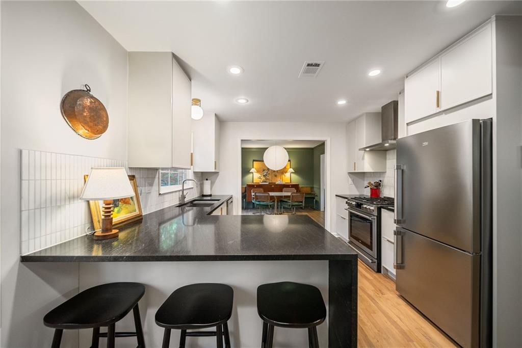 3359 Northbrook Drive Atlanta, GA 30340 - Photo 11 of 61 a kitchen with a table chairs refrigerator and microwave