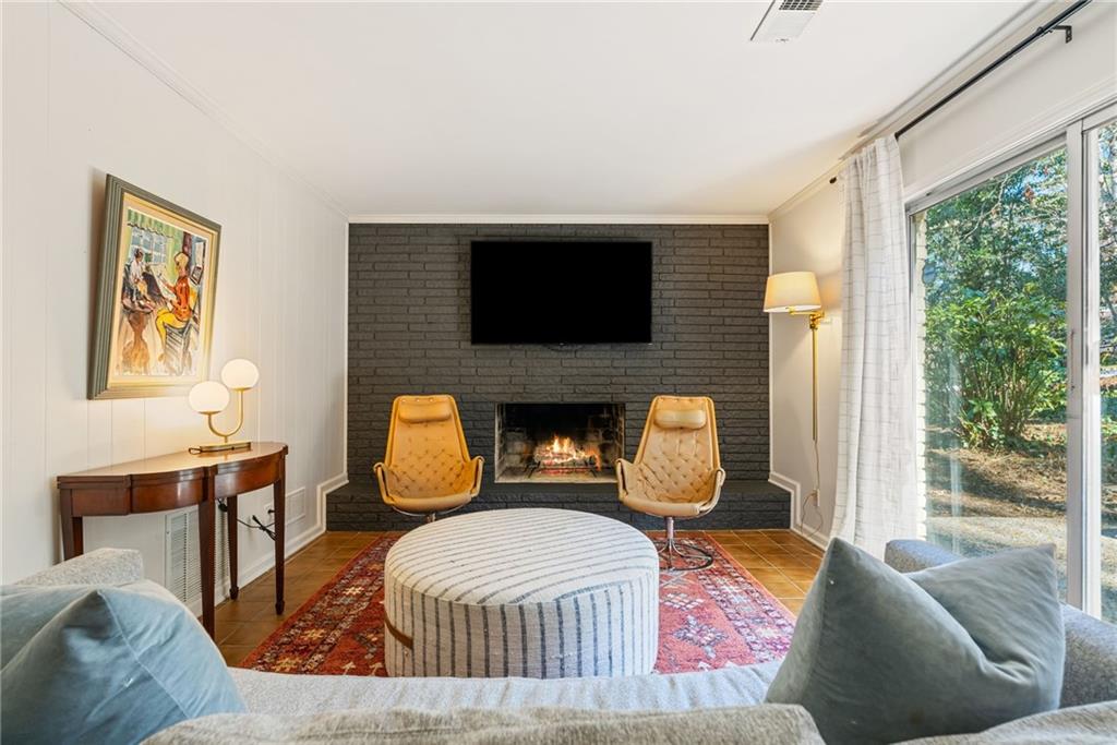 3359 Northbrook Drive Atlanta, GA 30340 - Photo 41 of 61 a living room with furniture a fireplace and a flat screen tv