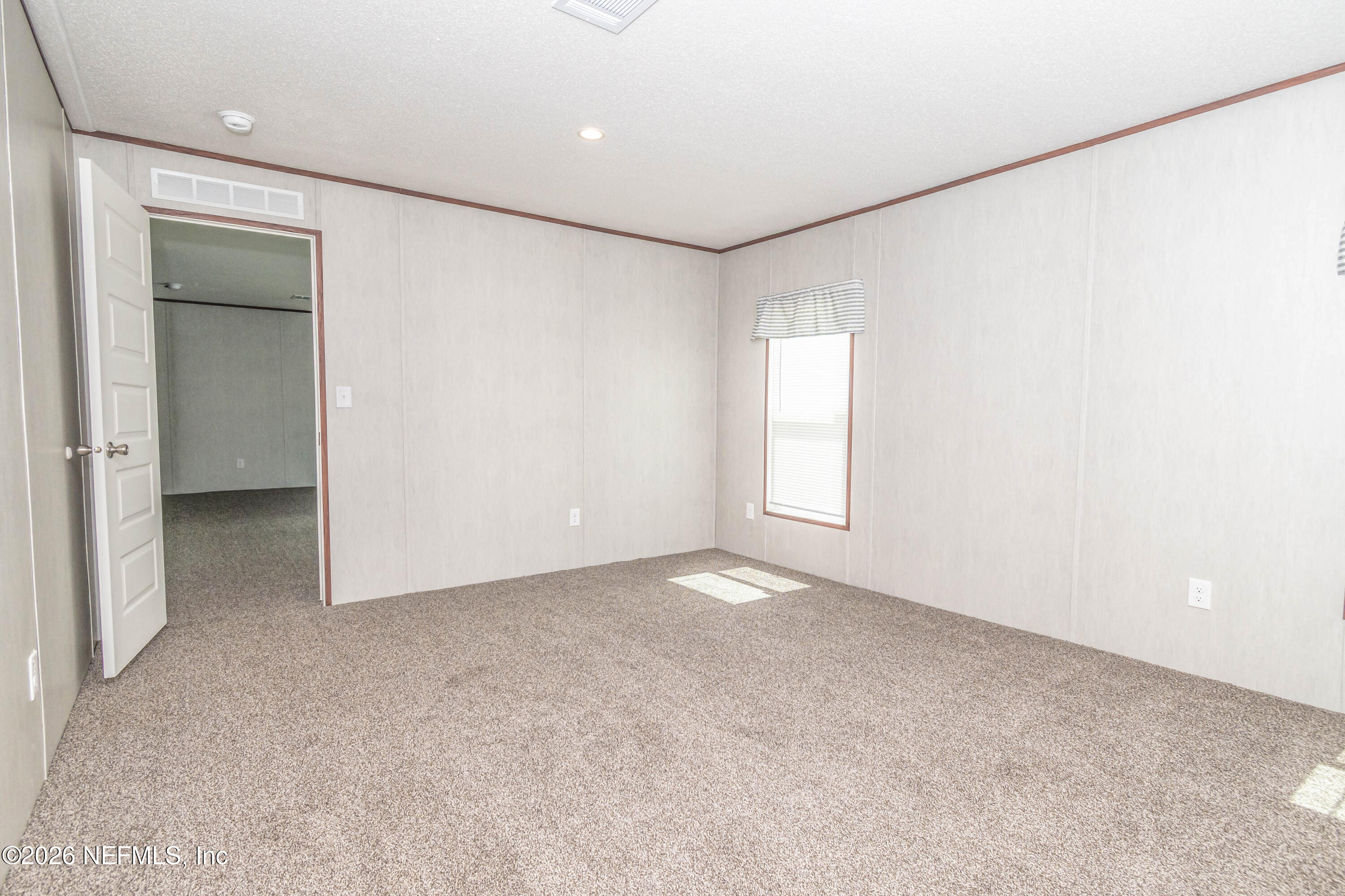 11355 Mallie Davis Road Glen St. Mary, FL 32040 - Photo 13 of 28 an empty room with windows and closet