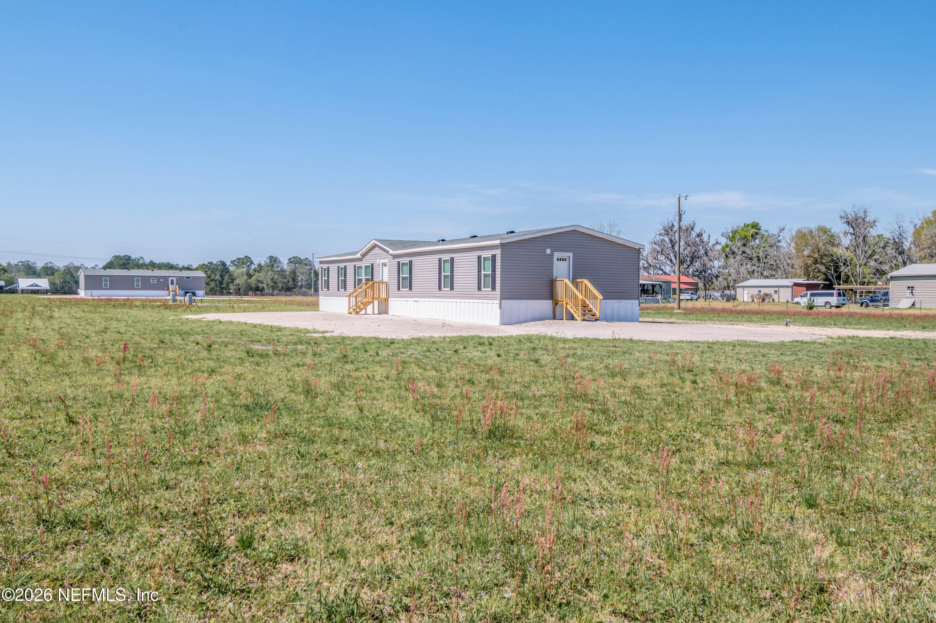 11355 Mallie Davis Road Glen St. Mary, FL 32040 - Photo 23 of 28 a view of a house with a yard and sitting area