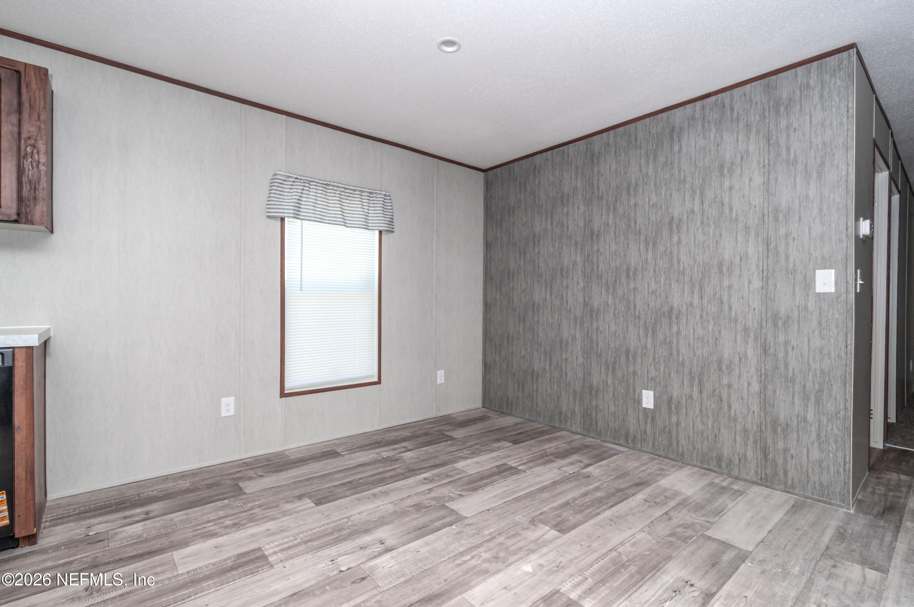 11355 Mallie Davis Road Glen St. Mary, FL 32040 - Photo 4 of 28 a view of an empty room with wooden floor and a window