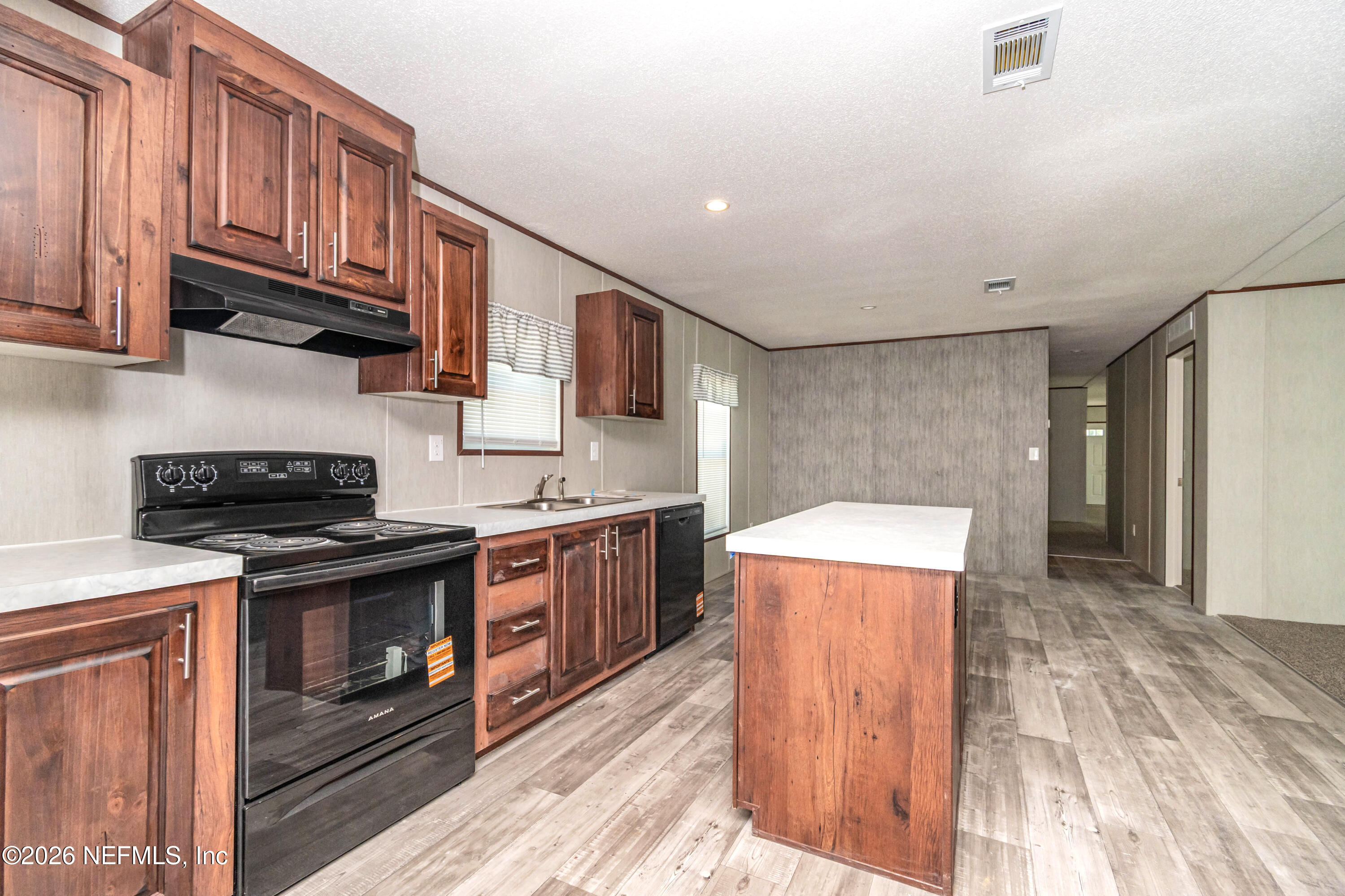 11355 Mallie Davis Road Glen St. Mary, FL 32040 - Photo 5 of 28 a kitchen with stainless steel appliances granite countertop a stove and a refrigerator