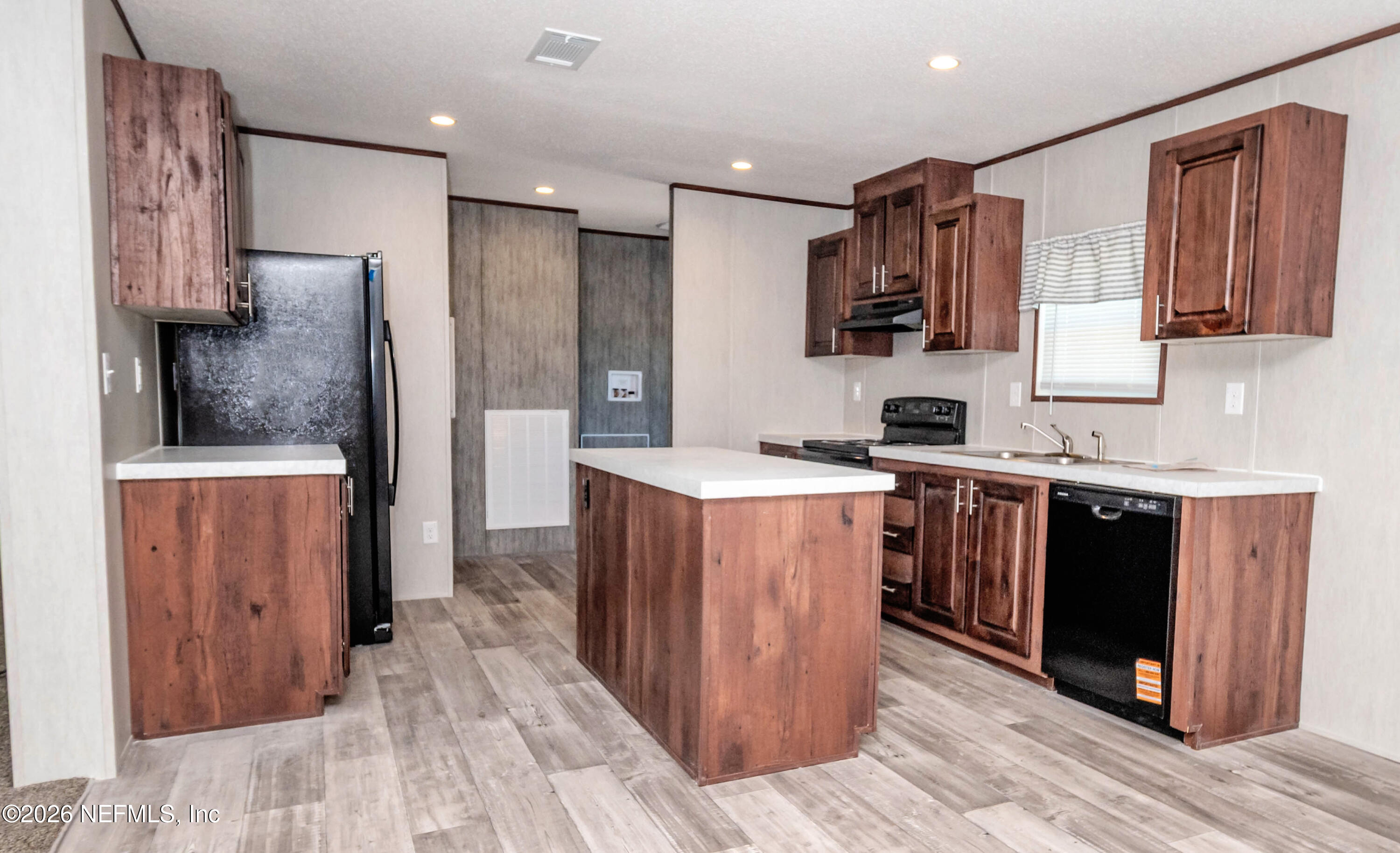 11355 Mallie Davis Road Glen St. Mary, FL 32040 - Photo 6 of 28 a kitchen with stainless steel appliances granite countertop a stove a sink and a refrigerator