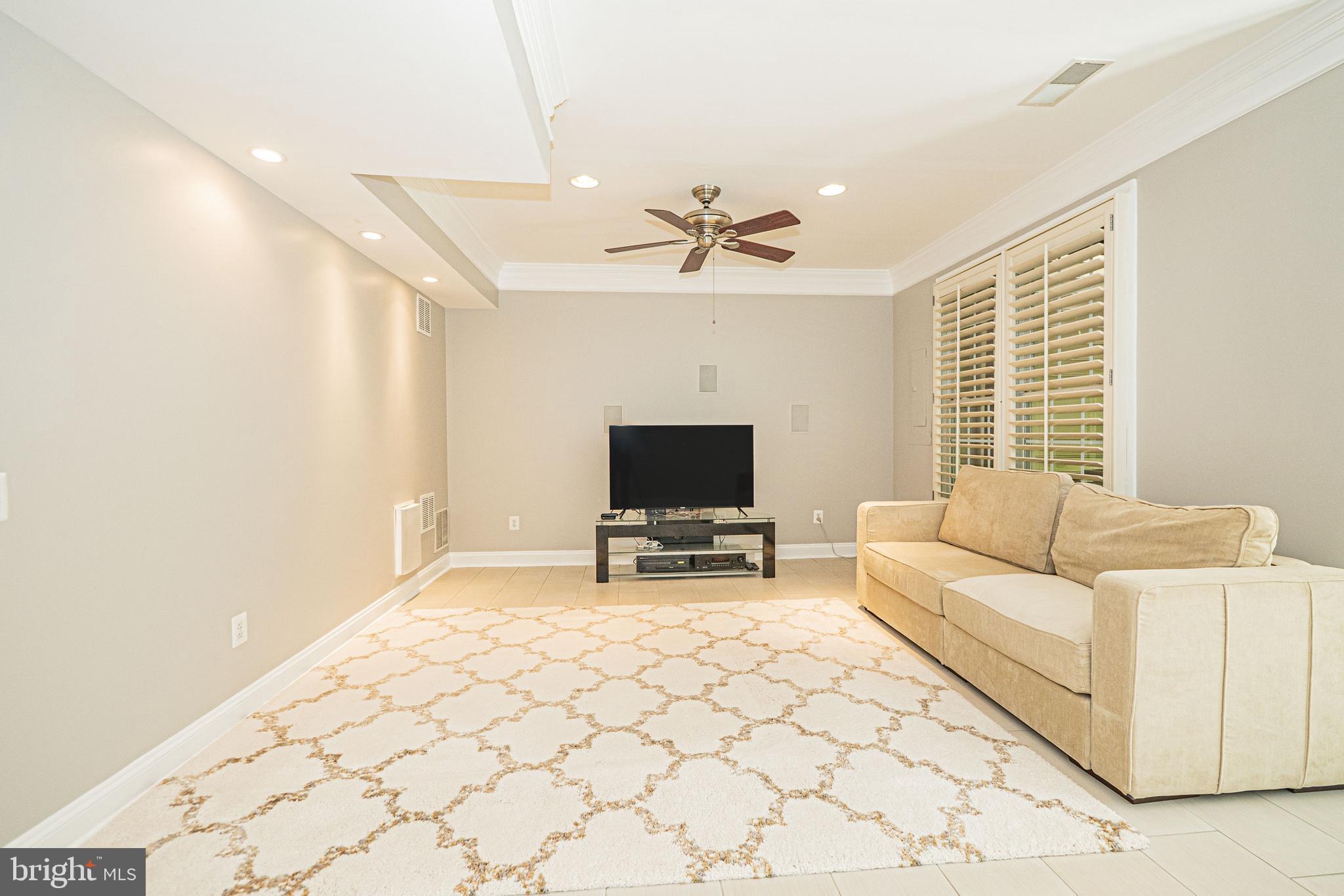 5448 Edsall Ridge Place Alexandria, VA 22312 - Photo 37 of 52 a living room with furniture and a flat screen tv