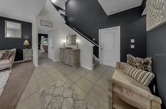 a spacious bedroom with a bed couch and a window