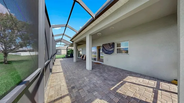 a backyard of a house with lots of green space and lake view