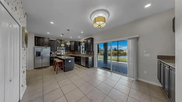 a kitchen with stainless steel appliances granite countertop a refrigerator and a sink