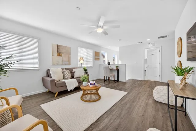 a living room with furniture and wooden floor