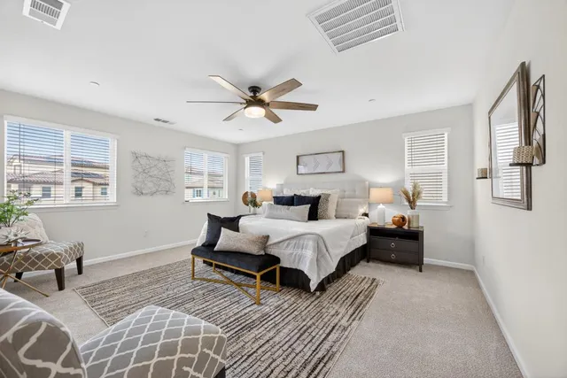 a bedroom with a large bed and a window