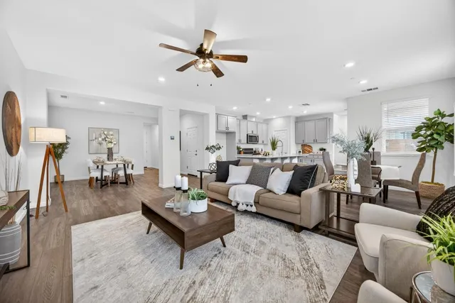 a living room with furniture and kitchen view