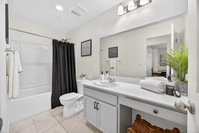 a bathroom with a double vanity sink toilet and shower