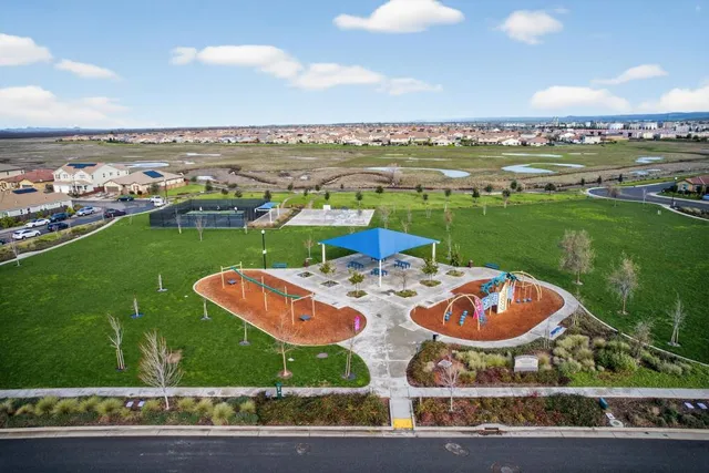 an aerial view of a house with garden space and outdoor seating