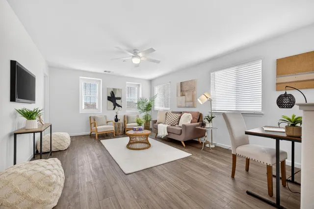 a living room with furniture fireplace and a window