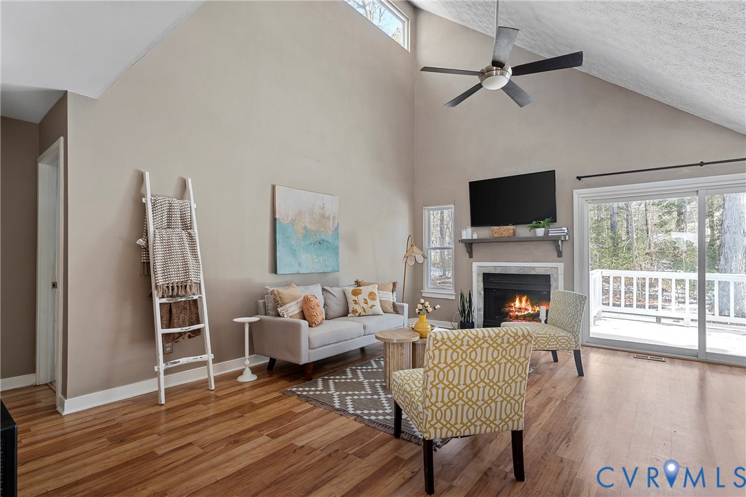 3025 3 Bridges Road Midlothian, VA 23112 - Photo 4 of 22 Living area featuring ceiling fan, a lit fireplace