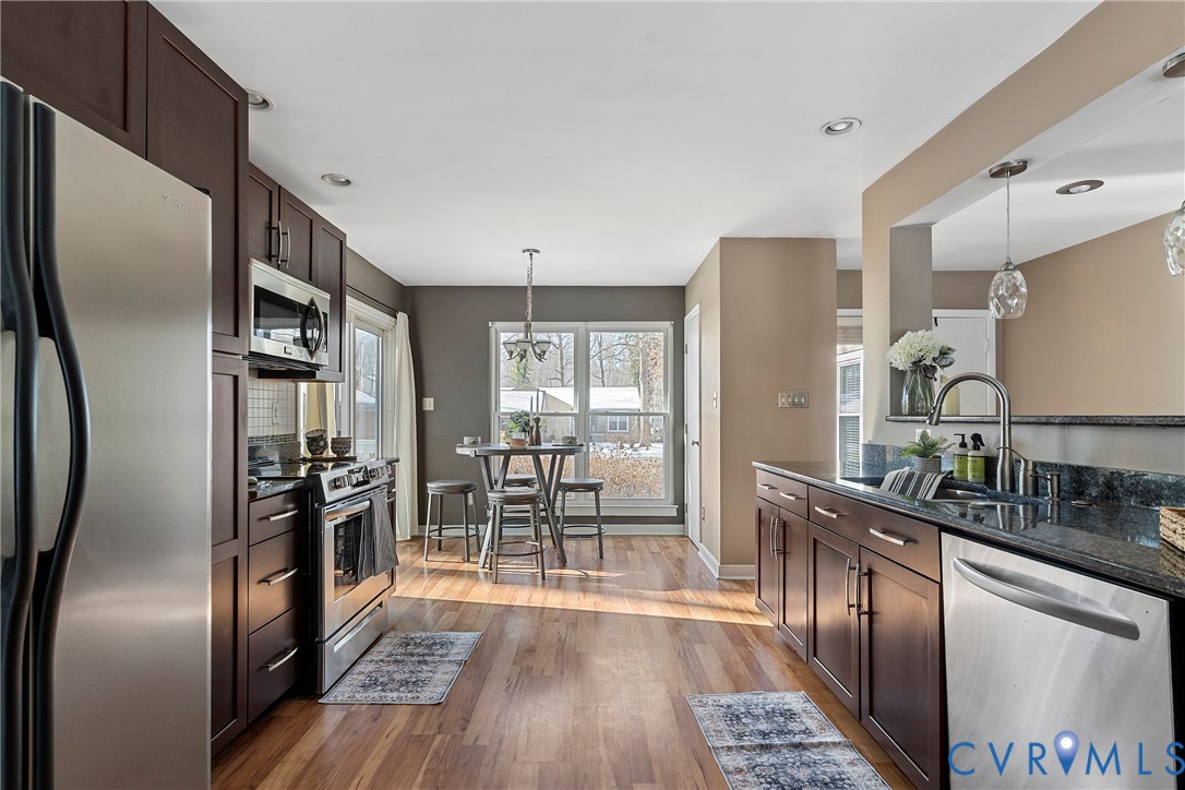 3025 3 Bridges Road Midlothian, VA 23112 - Photo 8 of 22 Kitchen featuring dark wood finish cabinets, stain