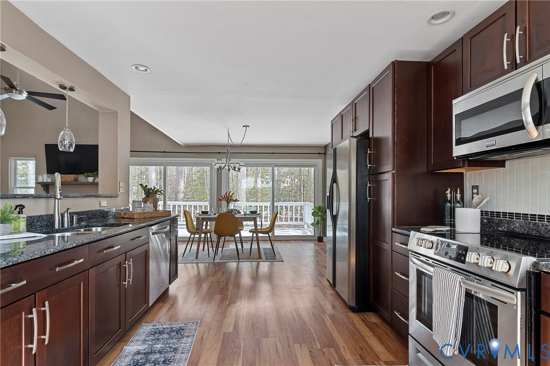 3025 3 Bridges Road Midlothian, VA 23112 - Photo 10 of 22 Kitchen with dark wood finish cabinetry, stainless