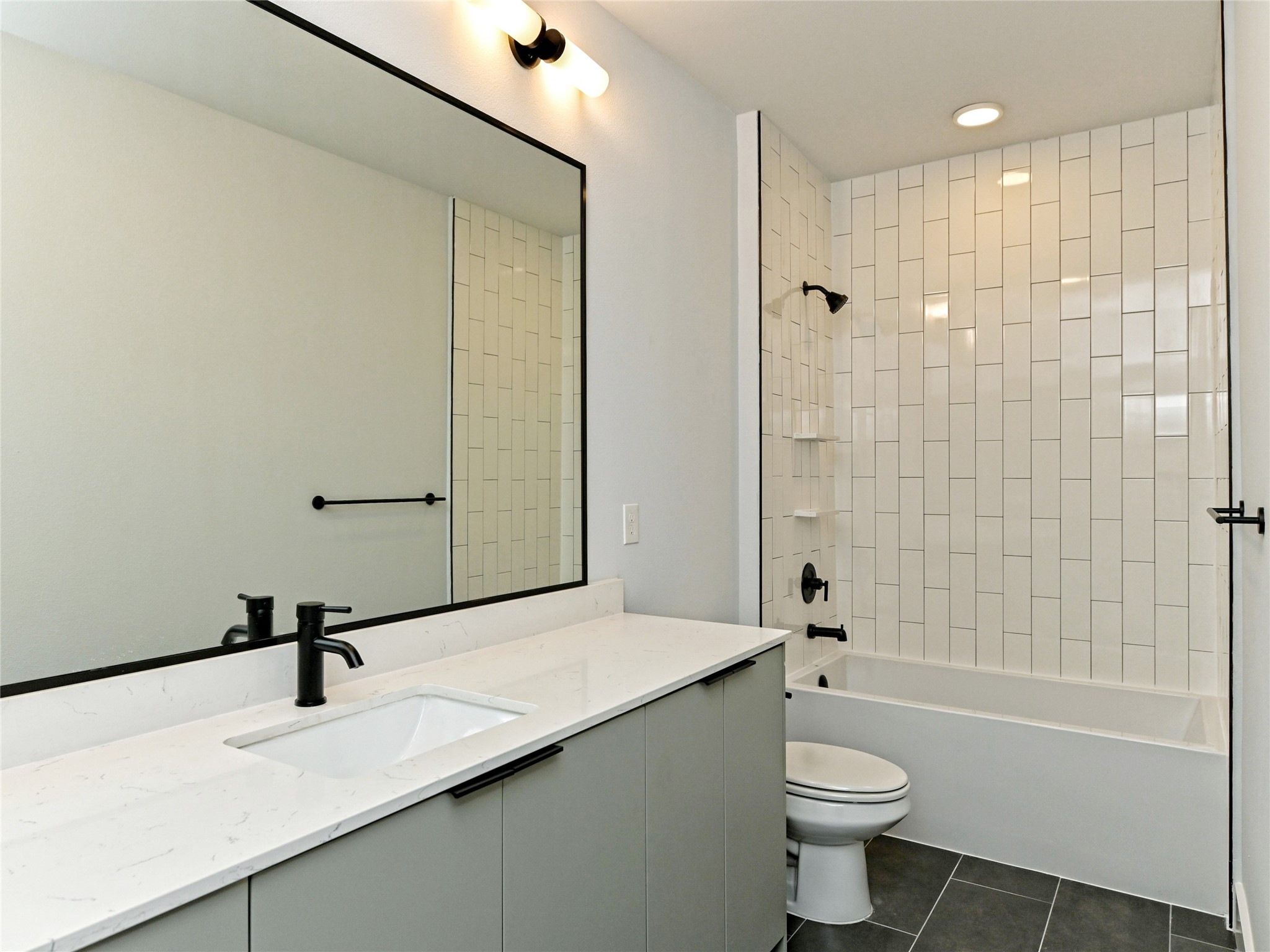 2500 Longview Street, Unit 518 Austin, TX 78705 - Photo 11 of 20 Full bath featuring tile patterned flooring, vanity, toilet, and shower / washtub combination