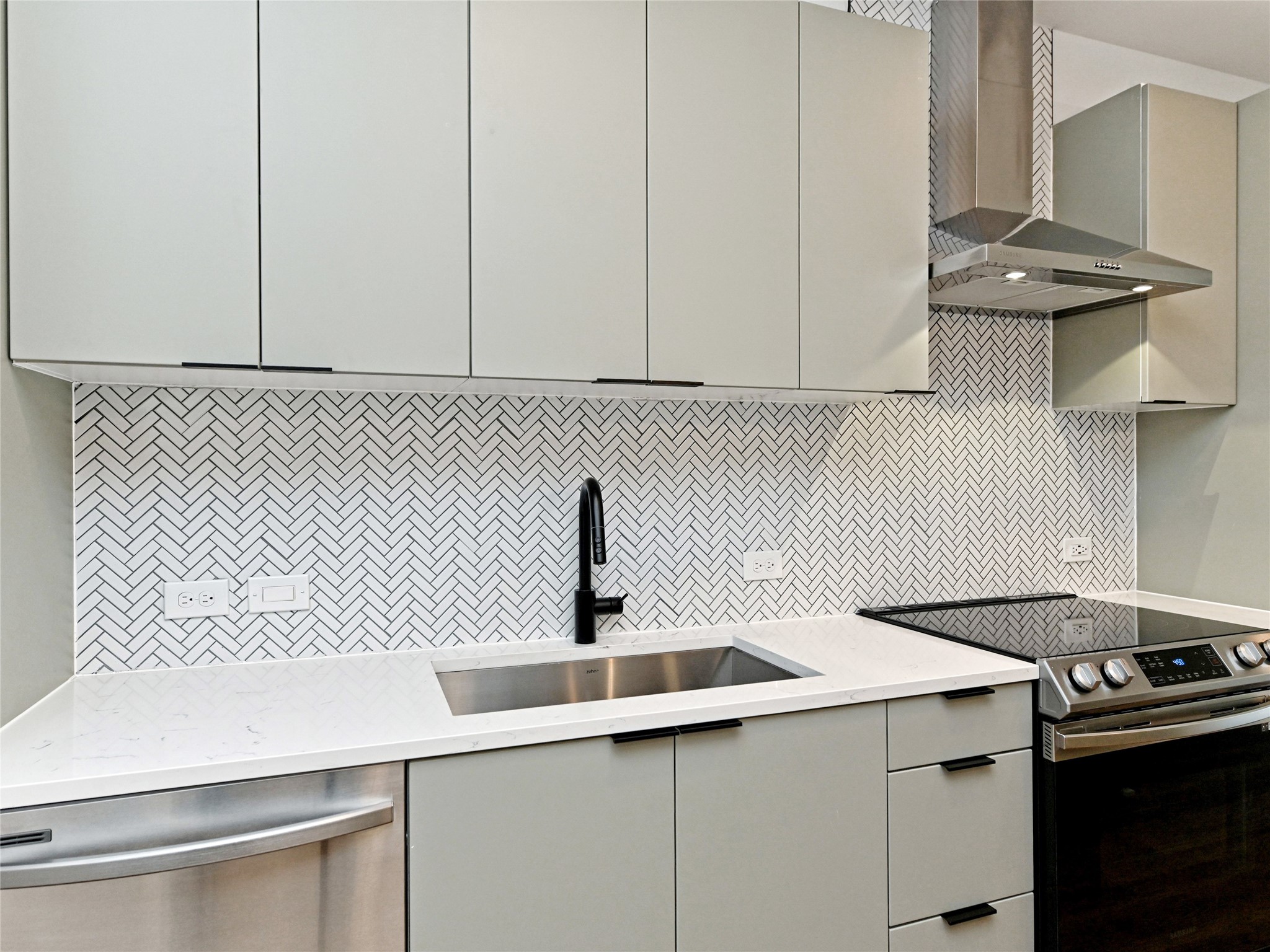 2500 Longview Street, Unit 518 Austin, TX 78705 - Photo 3 of 20 Kitchen with appliances with stainless steel finishes, wall chimney range hood, and gray cabinets