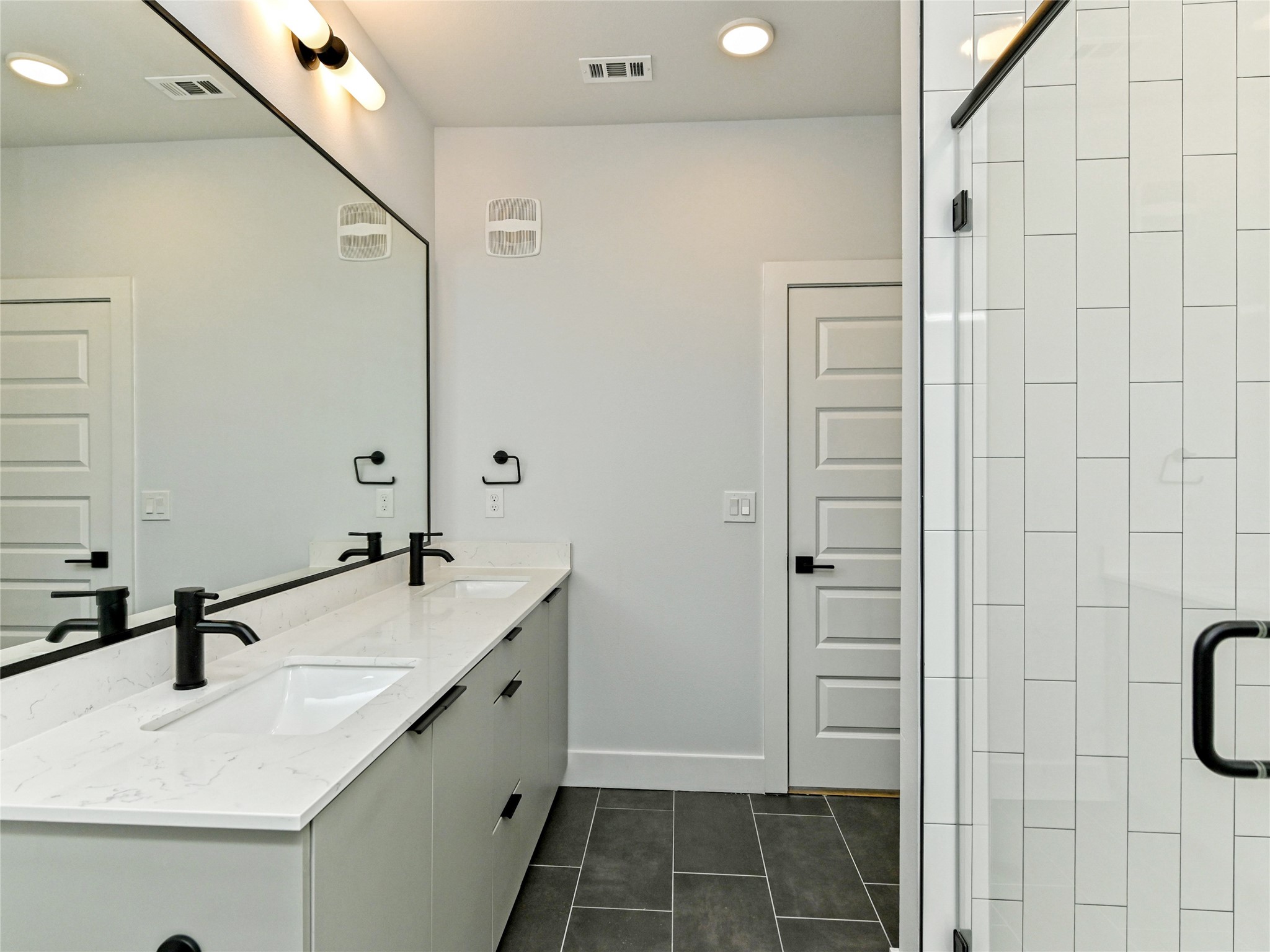 2500 Longview Street, Unit 518 Austin, TX 78705 - Photo 8 of 20 Bathroom with tile patterned floors, double vanity, a shower stall, baseboards, and recessed lighting