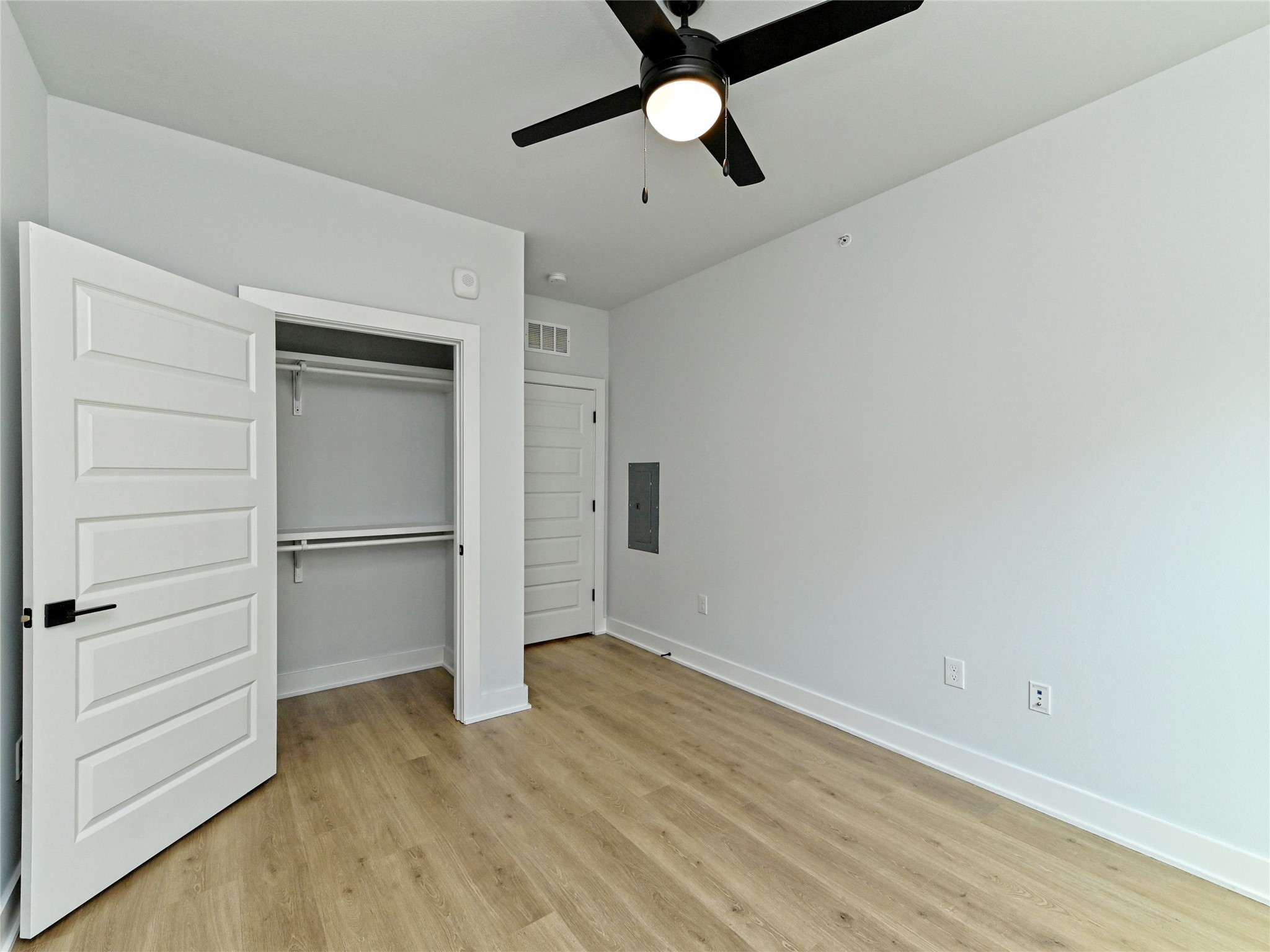 2500 Longview Street, Unit 518 Austin, TX 78705 - Photo 10 of 20 The second bedroom with light wood finished floors, electric panel, baseboards, and a closet