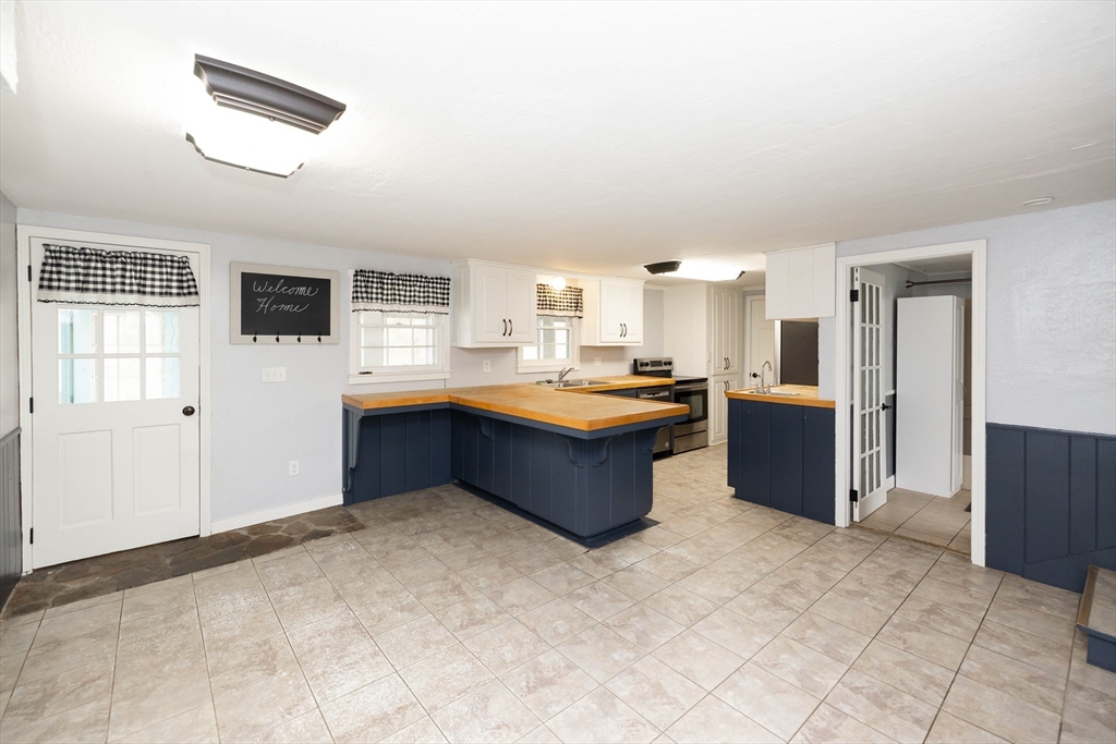39 Fiskdale Road Brookfield, MA 01506 - Photo 4 of 41 a large kitchen with kitchen island a sink stainless steel appliances and cabinets