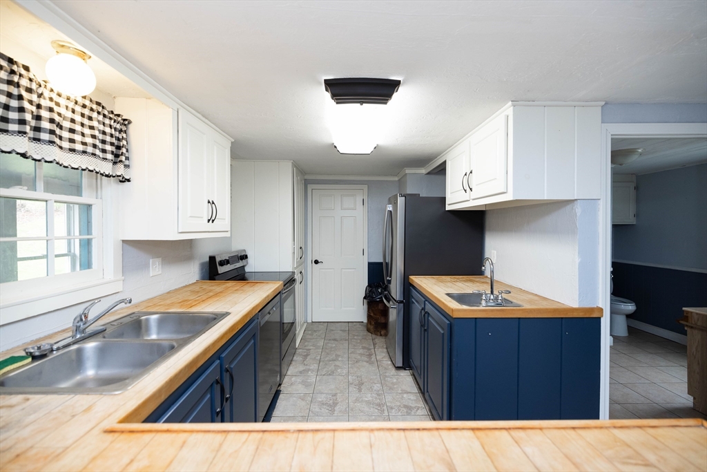 39 Fiskdale Road Brookfield, MA 01506 - Photo 5 of 41 a kitchen with stainless steel appliances granite countertop a sink and a stove