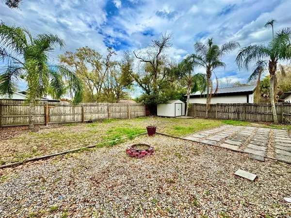 a backyard of a house with table and chairs