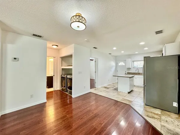a view of a kitchen with a refrigerator and a window