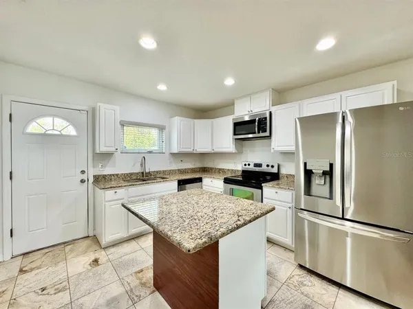 a kitchen with a refrigerator a stove a sink and a refrigerator
