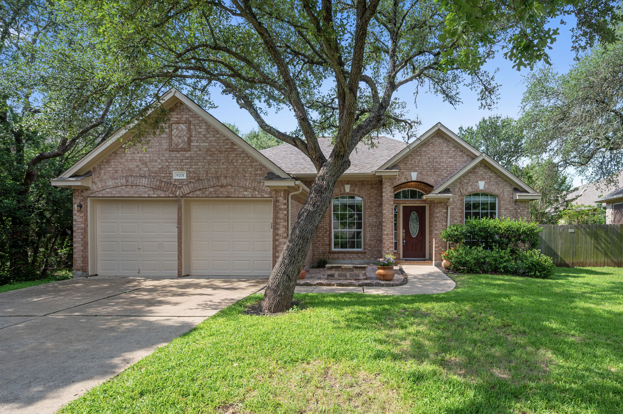 9201 La Siesta Bend Austin, TX 78749 - Photo 2 of 37 a front view of a house with a yard and garage