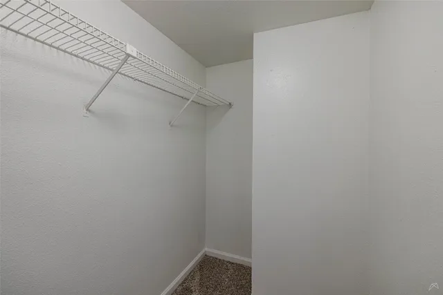 an empty room with a fan and a fan