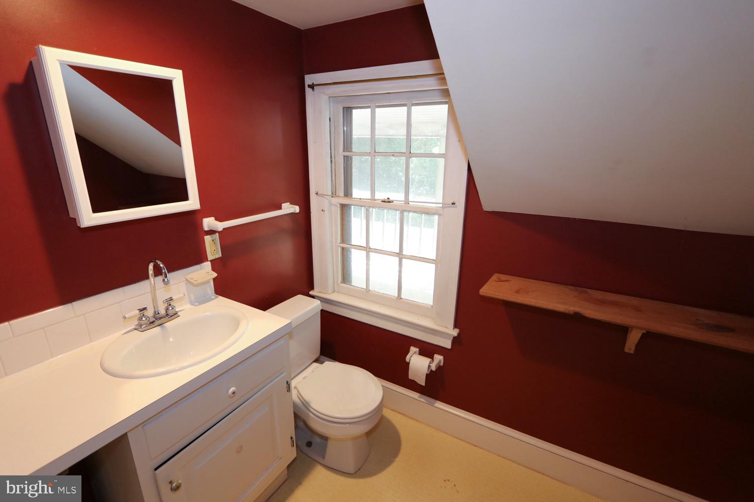 2701 Alden Road Bryn Athyn, PA 19006 - Photo 89 of 105 a bathroom with a toilet a sink a mirror and a window