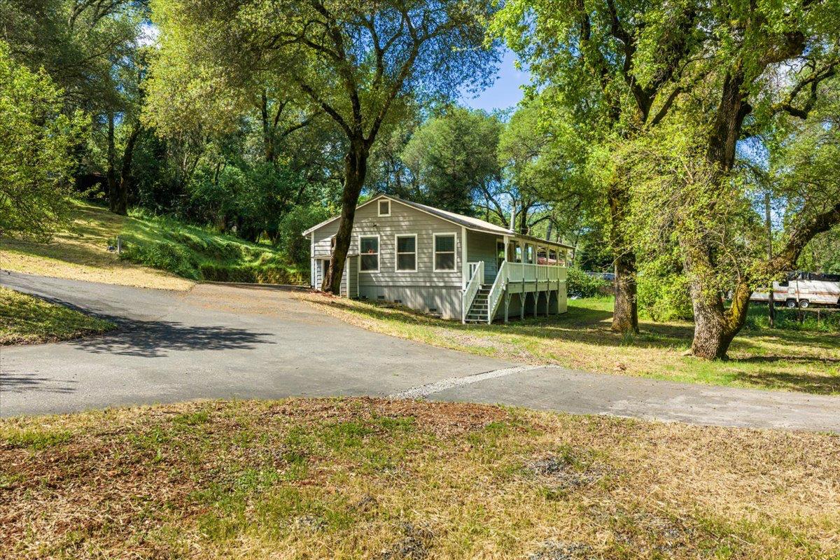 13630 Dry Creek Road Auburn, CA 95602 - Photo 15 of 46 a front view of a house with a yard and garage