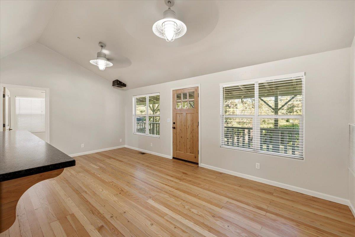13630 Dry Creek Road Auburn, CA 95602 - Photo 25 of 46 a view of an empty room with wooden floor and a window