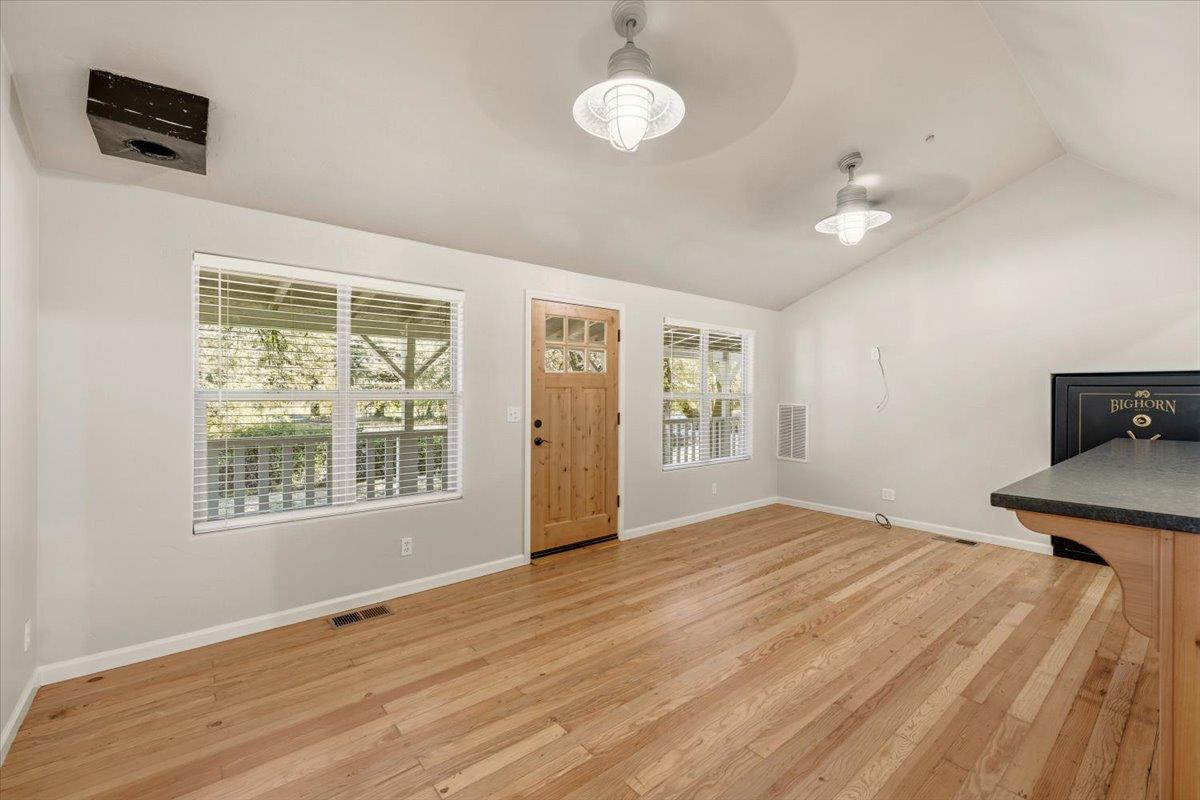 13630 Dry Creek Road Auburn, CA 95602 - Photo 26 of 46 a view of an empty room with a window and wooden floor
