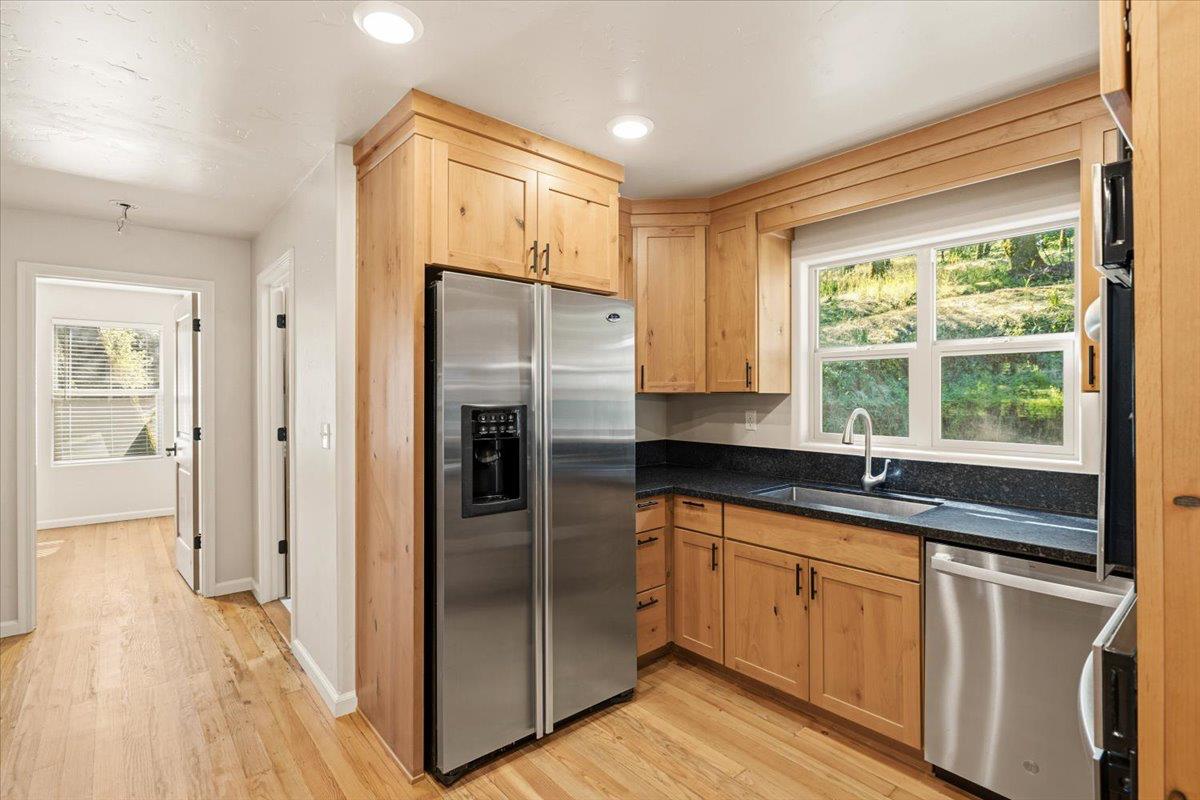 13630 Dry Creek Road Auburn, CA 95602 - Photo 31 of 46 a kitchen with stainless steel appliances granite countertop a refrigerator and a sink