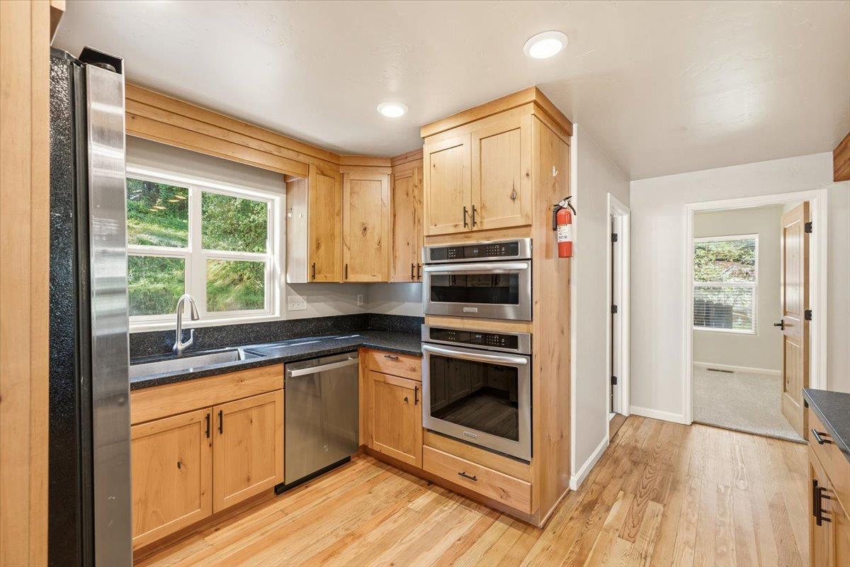 13630 Dry Creek Road Auburn, CA 95602 - Photo 32 of 46 a kitchen with a sink stove and cabinets