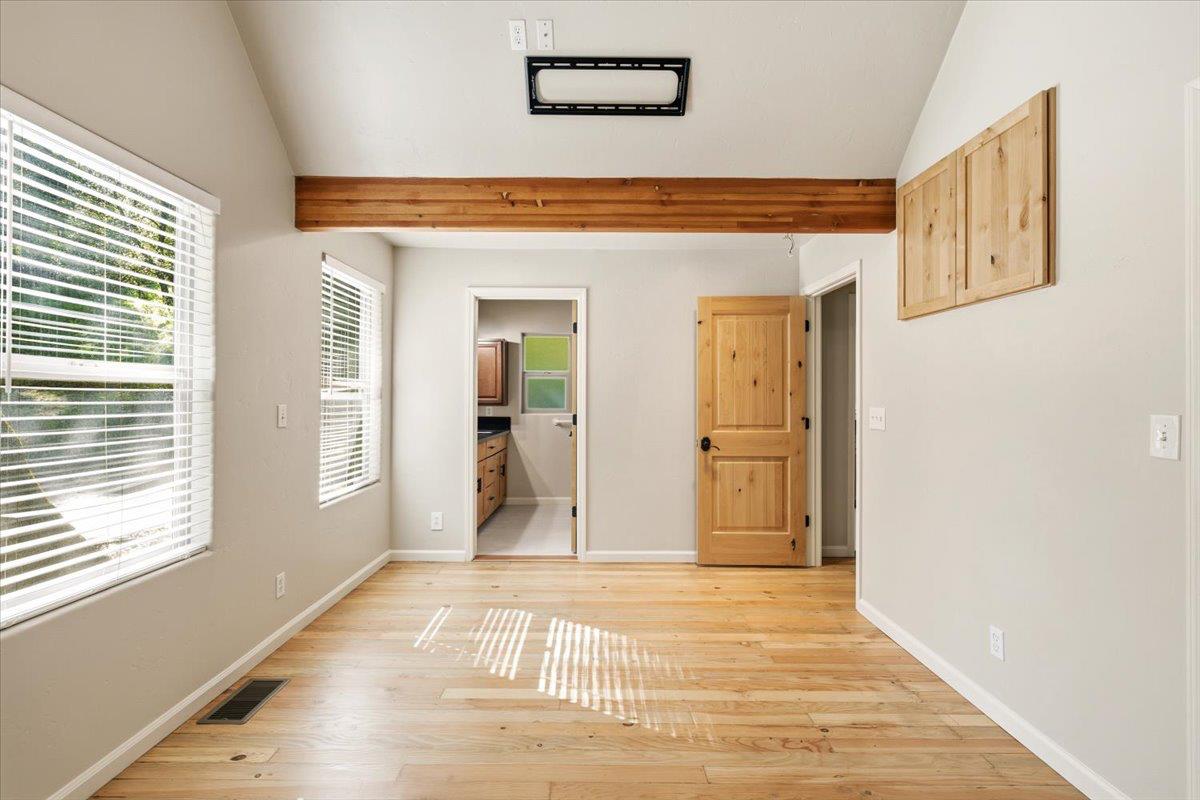 13630 Dry Creek Road Auburn, CA 95602 - Photo 37 of 46 a view of a hallway with wooden floor and a living room