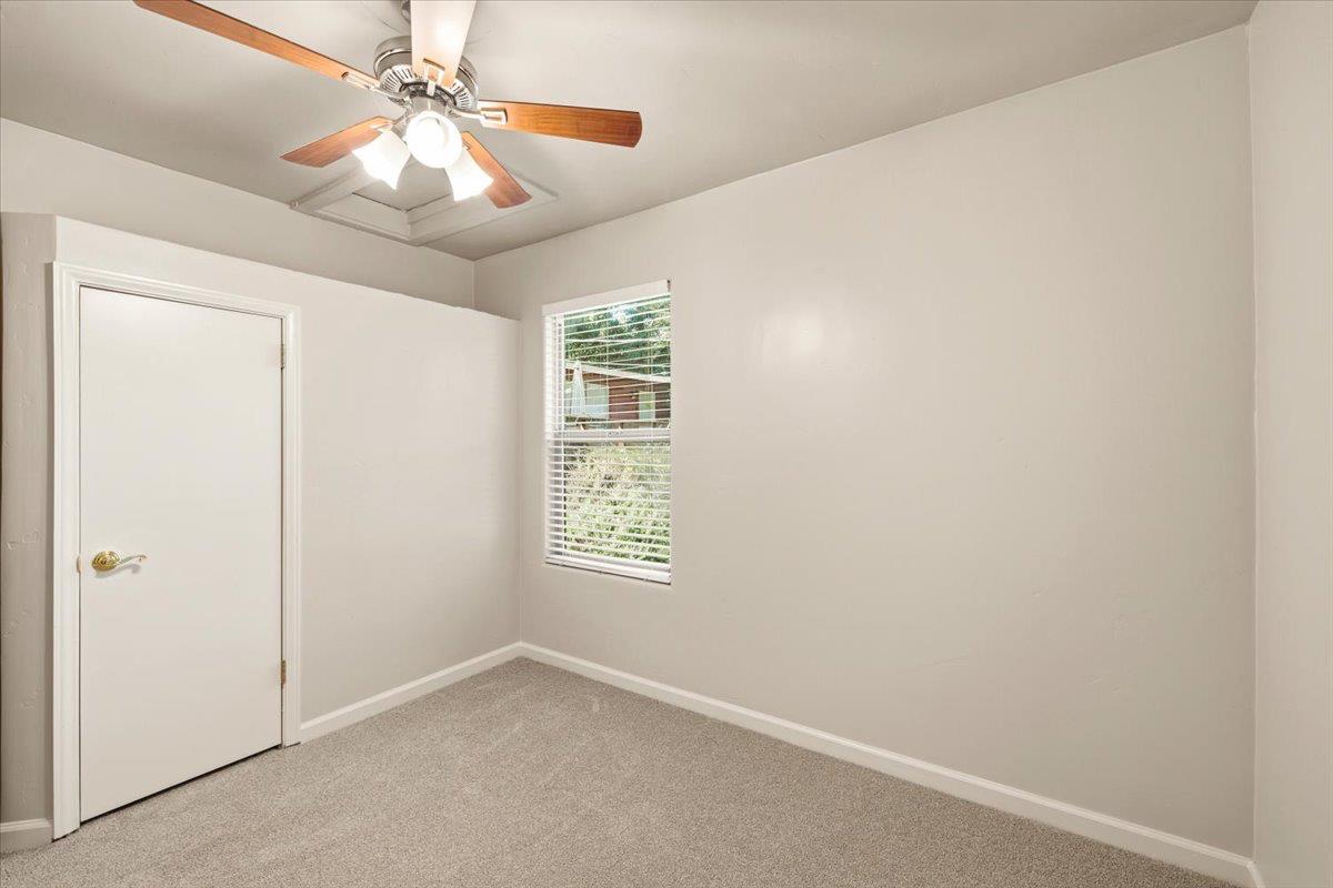 13630 Dry Creek Road Auburn, CA 95602 - Photo 43 of 46 an empty room with windows and fan