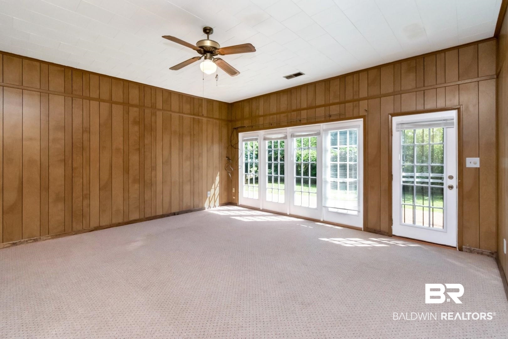 1477 Fairfield Street Mobile, AL 36606 - Photo 23 of 34 Unfurnished room with carpet, ceiling fan, and wooden walls