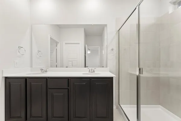 a bathroom with a shower sink and mirror