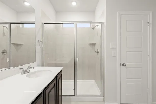 a bathroom with a double vanity sink and mirror