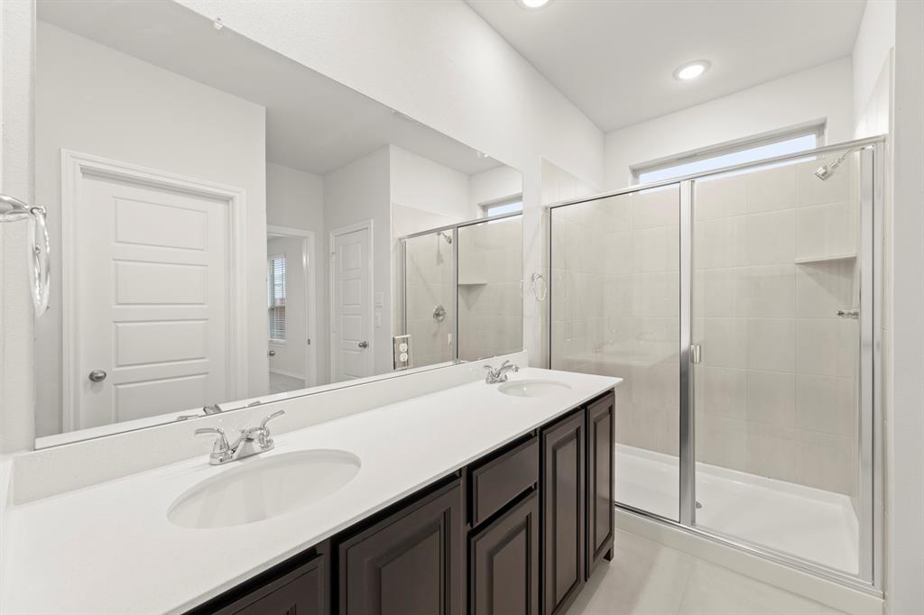 1708 Potomac Lane Blue Ridge, TX 75424 - Photo 23 of 27 a bathroom with a sink double vanity mirror and a shower