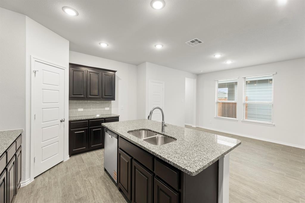 1708 Potomac Lane Blue Ridge, TX 75424 - Photo 7 of 27 a kitchen with granite countertop kitchen island stainless steel appliances a sink stove and refrigerator