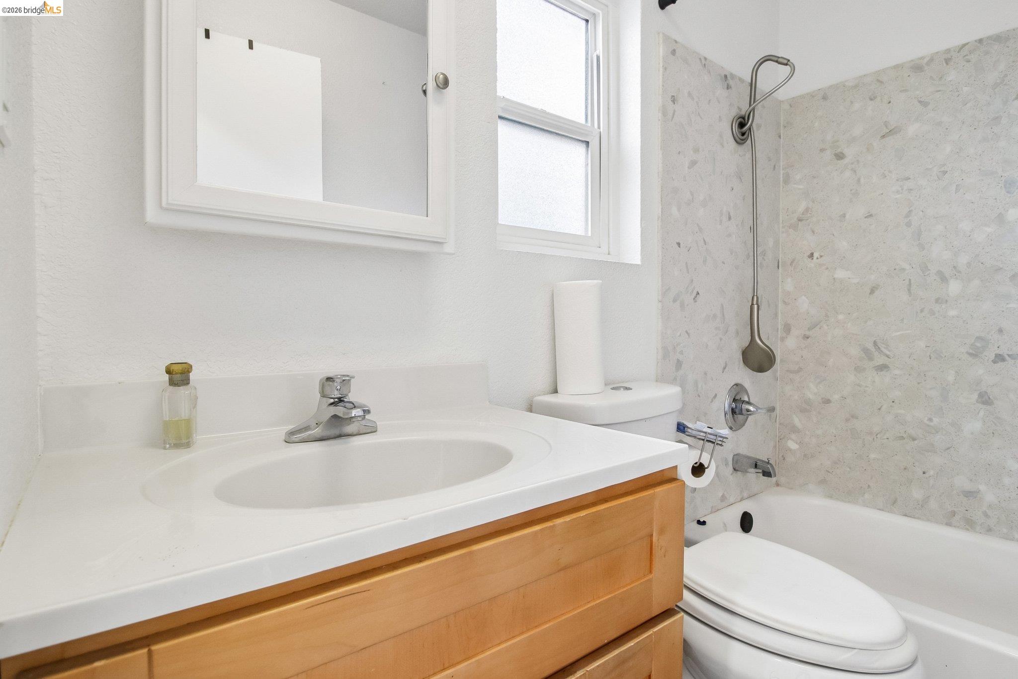 874 Pine Street Oakland, CA 94607 - Photo 13 of 39 Bathroom featuring a natural wood-finish vanity with a white countertop and integrated sink